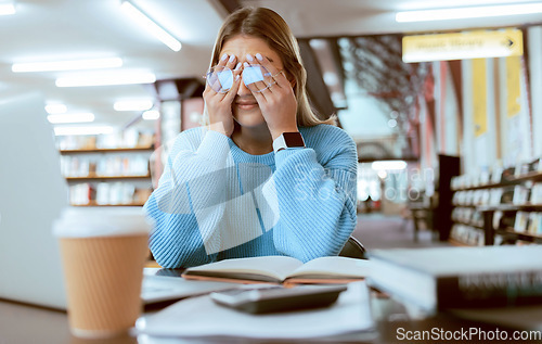 Image of Woman student with glasses, stress with headache and burnout, tired about paper deadline or study for exam in library. Campus, college studying fatigue with scholarship problem, pain and eye strain