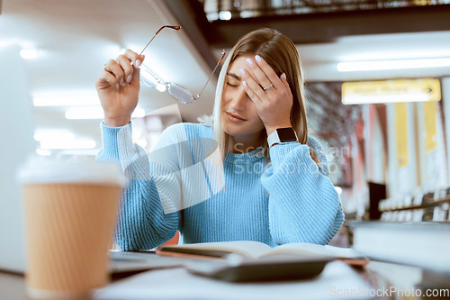 Image of Woman student, tired with headache and university burnout, stress about paper deadline or study for exam in library. Campus, college studying fatigue with scholarship problem, pain and mental health