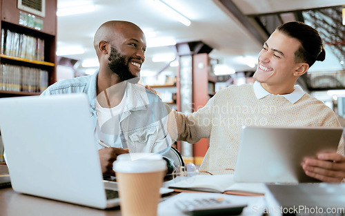 Image of Students, men and library with study support at desk with laptop, tablet and happy for learning opportunity. Student friends, laugh together and vision for university success, diversity and teamwork