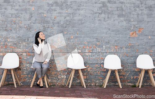 Image of Phone call, thinking in waiting room and woman with chairs, job recruitment and employment with smile in Japan. Happy person sitting on chair with smartphone, smiling and talking with mockup space.