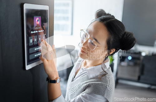 Image of Music, tablet and Asian woman with digital system in home, apartment and living room. Technology, futuristic design and girl typing song, track and audio on ai software, biometrics and user interface
