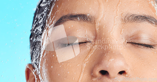 Image of Shower water, face cleaning and black woman washing with liquid for hydration, beauty healthcare or skincare hygiene. Self care studio, spa salon and relax closeup model isolated on blue background