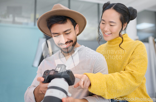 Image of Creativity, photographer and woman in discussion with a camera choosing a image from photoshoot. Photography, art and young cameraman talking to a model to choose the best picture in creative studio.