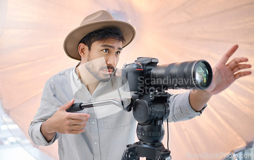 Image of Photographer, camera and photoshoot with man and photography, focus and lens with direction and creativity. Creative, art and fashion with person on set or photo studio with cameraman working