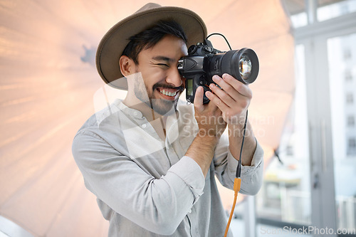 Image of Photography, studio and camera with a man photographer taking a picture backstage during a photoshoot. Creative, light and production with a male using a photographic lens to take a photograph