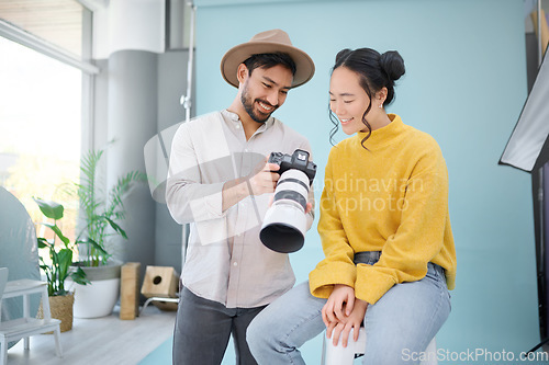 Image of Creative, photographer and model choosing a picture on the camera from the photoshoot in the studio. Photography, creativity and cameraman talking to a woman for the best image on a artistic set.