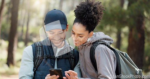 Image of Hiking, smartphone and travel couple with location search, online travel guide or nature journey planning together in a forest on 5g network. Backpack trekking people using phone mobile app in woods