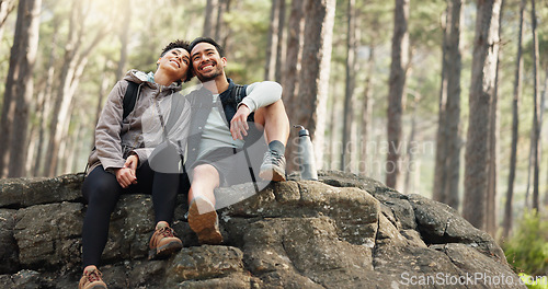 Image of Hiking, forest and nature couple people on rock for journey, adventure or wellness lifestyle with trees, fitness gear and backpack. Trekking, relax and diversity friends travel in mountains or woods