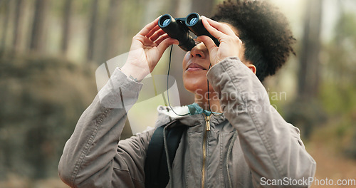 Image of Hiking, forest and woman with binocular watch nature scenery, view or bird watching while trekking through trees. Adventure woods, travel journey or Brazil black girl backpacking in Amazon Rainforest