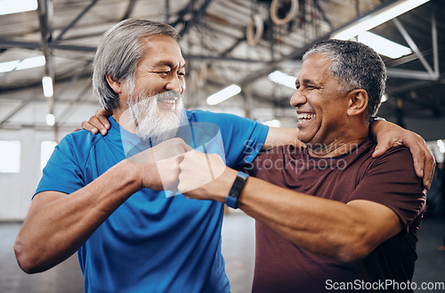 Image of Men, gym and training with fist bump, smile and teamwork motivation for diversity, friends hug or happiness. Senior fitness partnership, asian and black man for mma workout, exercise or team building