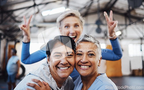 Image of Business women, senior portrait and happiness of company friends in a warehouse with peace sign. Smile, teamwork hug and mature female group of happy entrepreneur staff ready for working together