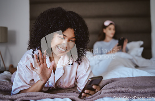 Image of Video call, phone and wave with black woman at sleepover for communication, internet and contact. Happy, relax and smile with girl and friends in bedroom with technology, digital and social media