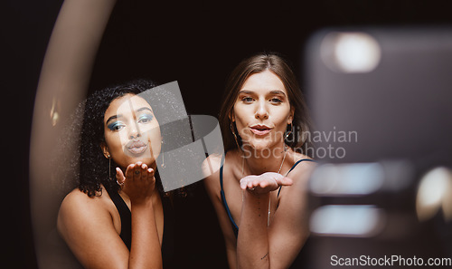 Image of Beauty, fashion and woman friends blowing a kiss together while recording a vlog as an influencer team. Social media, makeup and affection with a female and friend live streaming a broadcast