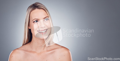 Image of Woman, thinking and skincare aesthetic with mockup in a studio for wellness and cosmetics. Facial, smile and happy model with gray background and mock up ready for dermatology and self care treatment
