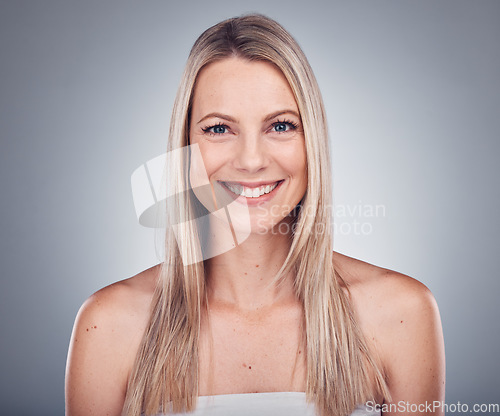 Image of Woman, portrait and smile with hair and beauty, hairstyle cosmetic care and glow isolated on studio background. Makeup, natural cosmetics and keratin treatment, dermatology and shine with skincare