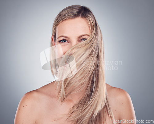 Image of Portrait, woman and hair care for shine, beauty and salon treatment with girl on grey studio background. Face, female and lady with a clean scalp, grooming routine and luxury style and confidence