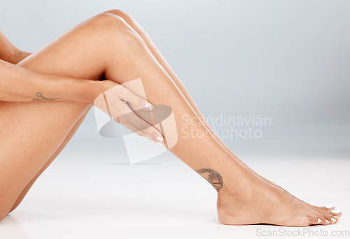 Image of Epilation, woman legs and body skincare of a model with laser hair removal for spa advertisement. White background, studio and isolated young person with mockup, wellness and cosmetic treatment