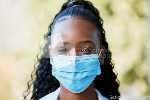 Image of Covid, portrait and doctor at hospital with mask for compliance, safety and healthcare on bokeh background. Face, corona and female health expert at a clinic for help, goal and innovation outside