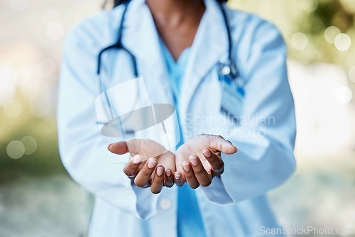 Image of Healthcare, doctor and hands open to help in giving health care, support and volunteer in hospital in Africa. Black woman medical worker, stethoscope and helping hand in trust working charity clinic.