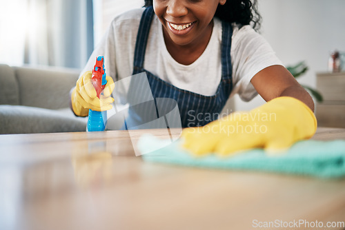 Image of Hand, cleaning and latex gloves with a black woman using a cloth in a home for hygiene as a housekeeper. Furniture, bacteria and chemical with a female cleaner working in housekeeping in an apartment