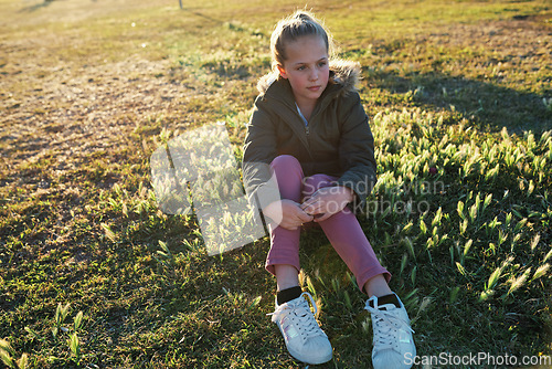 Image of Relax, calm and girl thinking on the grass during summer for vacation, peace and zen in New Zealand. Young, peaceful and child sitting in a park in nature in the morning for relaxation in youth