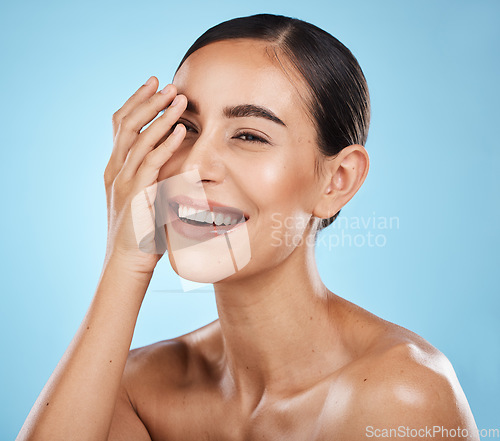 Image of Beauty, skincare and happy woman in a studio for a wellness, health and natural face routine. Self care, cosmetic and excited female model with a facial skin treatment isolated by blue background.