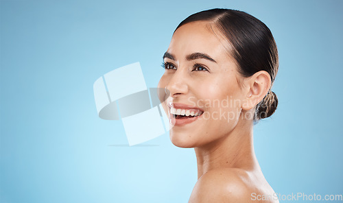 Image of Happy woman, beauty and isolated on studio background for skincare, cosmetics or makeup with mockup space. Smile on face of model or person with aesthetic, dermatology and facial glow on blue mock up