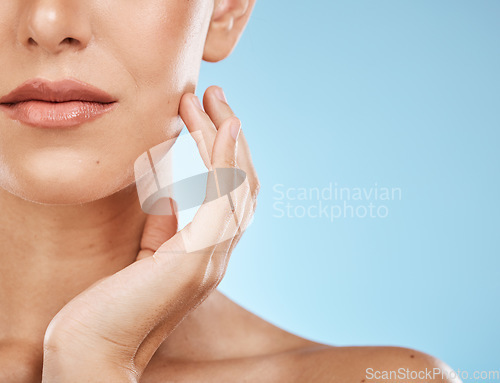 Image of Half, face and woman for skincare, beauty and touching isolated on a blue background in a studio. Mockup, cosmetics and facial check of a model feeling skin for acne, problem and eczema on a backdrop