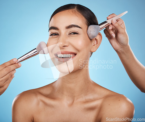 Image of Face portrait, hands and makeup brush of woman in studio isolated on blue background. Aesthetics, facial cosmetics or skincare of happy female model with brushes for foundation, powder or dermatology