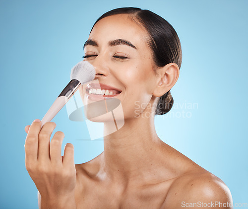 Image of Face, beauty and makeup brush of woman with eyes closed in studio isolated on blue background. Nose, facial and skincare aesthetic of happy female model with tools for foundation, powder or cosmetics