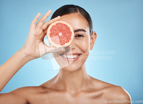 Image of Beauty, skin care and woman portrait with grapefruit face for dermatology, natural cosmetic and wellness. Happy aesthetic model for sustainable fruit facial, nutrition and glow on blue background