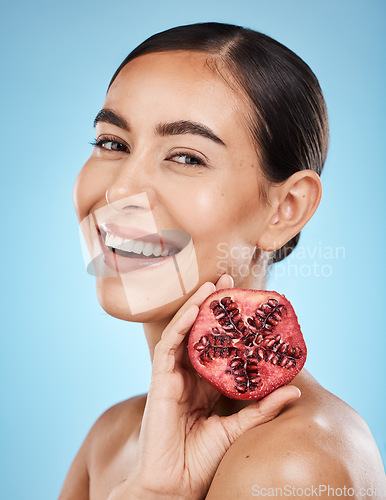 Image of Pomegranate, skin care and beauty woman portrait with fruit face for dermatology and cosmetics. Aesthetic model person for natural product facial glow, nutrition and healthy smile on blue background