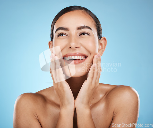 Image of Face, beauty and skincare of woman in studio isolated on a blue background. Aesthetics, makeup and cosmetics of happy female model with healthy, glowing and flawless skin after spa facial treatment.