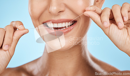 Image of Woman floss teeth zoom, smile and dental healthcare, fresh breath and mouth cleaning isolated on blue background. Face, hands and happy with oral hygiene product, healthy gums and flossing in studio