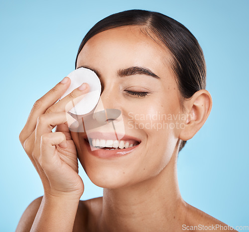 Image of Cotton, skincare and woman isolated on studio background for face, eye makeup and facial cleaning product. Happy model or person smile with beauty glow and using a cosmetics remover for self care