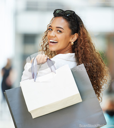 Image of Shopping mall, happy customer and woman portrait with paper bag for a sale, promotion or discount. Person with a smile for designer fashion or retail brand while walking with luxury mockup logo brand