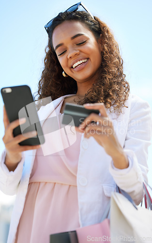 Image of Phone, credit card and woman in the city doing online shopping, paying debt or on her bank app. Happy, smile and female on a cellphone for a ecommerce retail sale, discount or promotion in town.