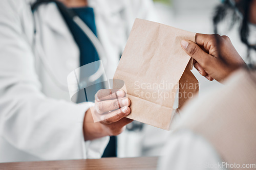 Image of Pharmacy, medication and pharmacist giving bag to a patient for treatment, cure or remedy. Healthcare, people and woman with a brown paper package from a chemist for medicine in a drugstore or clinic