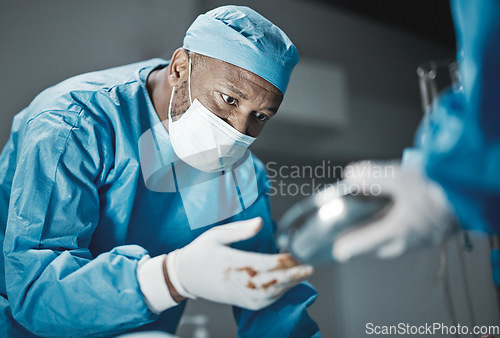 Image of Doctor, surgery and hospital theater with patient and black man surgeon for emergency, teamwork and trust. Professional medical worker in ppe for life saving tools, healthcare and health insurance