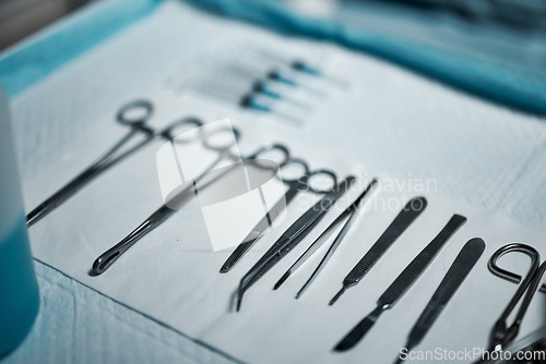 Image of Surgery, medical tools and hospital theater sterile for healthcare, health insurance or emergency. Metal surgical instrument scissors, forceps or kit on table with medicine in surgeon operating room