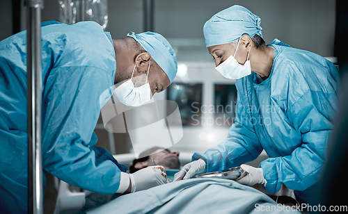 Image of Healthcare, surgery and doctors in hospital operating room for emergency operation on patient. Health clinic, collaboration or team of medical surgeons working with surgical tools to save life of man