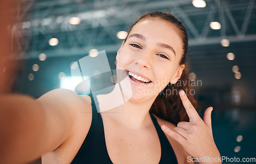 Image of Selfie, rock and portrait of a girl at a gym for fitness, running and health with a sign for a workout. Happy, sports and face of a girl with a photo, hand emoji and smile for exercise and sport