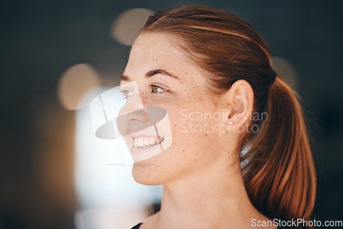 Image of Face, freckles and thinking with a redhead woman indoor feeling happy or positive about the future. Idea, ginger and carefree with an attractive young female standing alone on a dark background