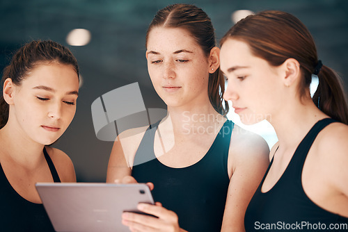 Image of Girls looking at tablet for fitness data, group of people using iot tech and indoor swimming pool. Instructor showing athletes digital workout, young swimmers use internet and performance analytics