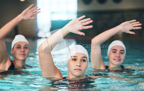 Image of Sports, swimming and athletes stretching in a pool before a competition, exercise or sport training. Fitness, water and women swimmers doing a warm up before a swim race or workout in swimwear.