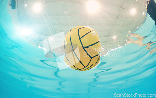 Image of Water polo, sports and ball in a pool from below with equipment floating on the surface during a competitive game. Fitness, training and exercise while a still life object floats during a match