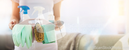 Image of Hands, cleaning and mockup with a woman housekeeper holding a basket of detergent or disinfectant in a home. Housekeeping, hygiene and mock up with a female cleaner carrying a plastic container