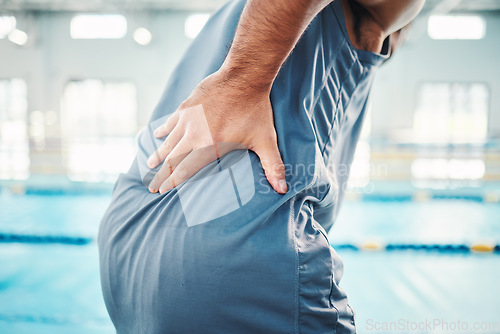 Image of Pain in back, sports and man by swimming pool with injury, muscle ache and inflammation from training. Health, medical care and male with accident, emergency or body bruise from fitness or exercise