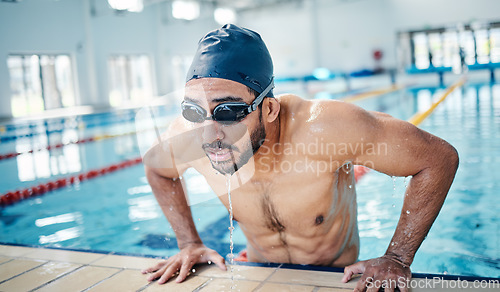 Image of Athletic, breathing and man swimming for fitness, training and race in a stadium pool. Tired, sports and face of an athlete swimmer doing cardio in the water for a workout, sport and competition