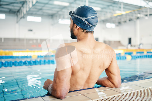 Image of Swimming cap, pool and back of a man preparing for competition, exercise or training in a pool. Sports, fitness and professional male swimmer standing ready for water workout, challenge or sport race